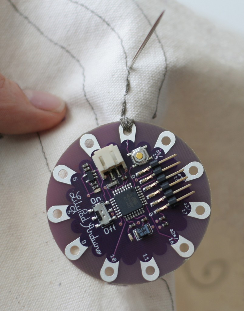 The LilyPad Arduino is a microcontroller board designed for wearables and e-textiles. Designed and developed by Leah Buechley and SparkFun Electronics.Creative Commons Attribution